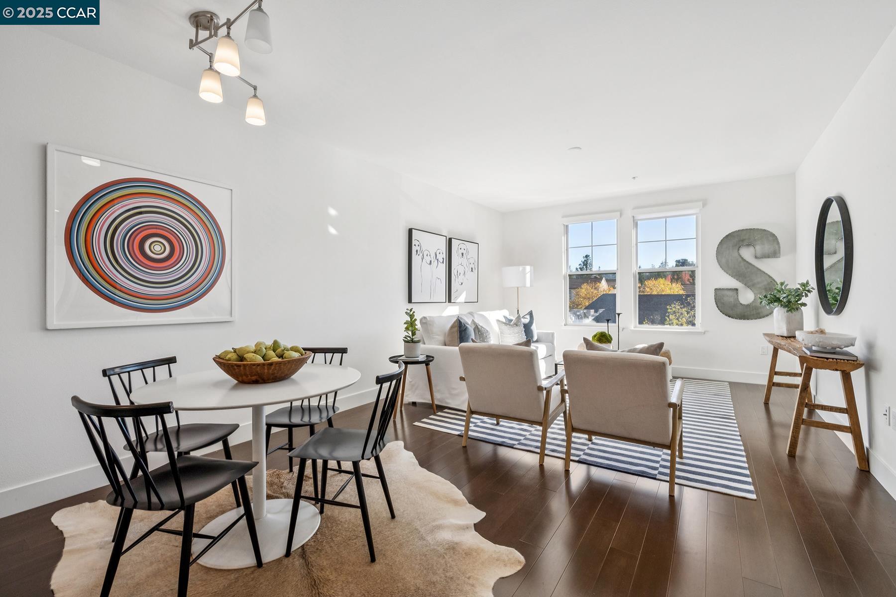 1000 Dewing Avenue, Unit 214 Lafayette, CA 94549 - Photo 2 of 23 a view of a dining room with furniture a chandelier and wooden floor