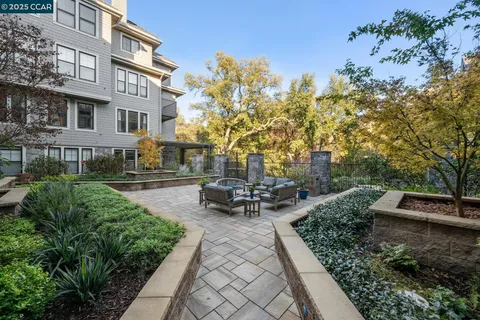a view of a building with garden and sitting area