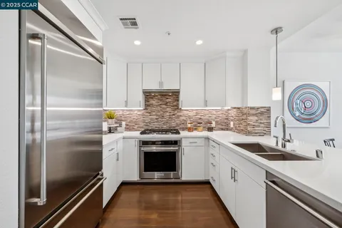 a kitchen with a sink and a refrigerator