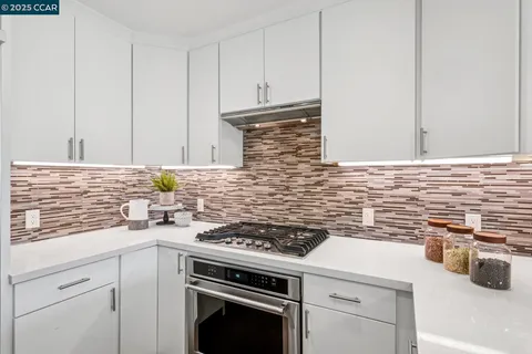 a kitchen with granite countertop cabinets stainless steel appliances and sink