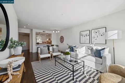 a living room with furniture and a painting on the wall