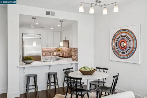 a kitchen with kitchen island granite countertop a table and chairs