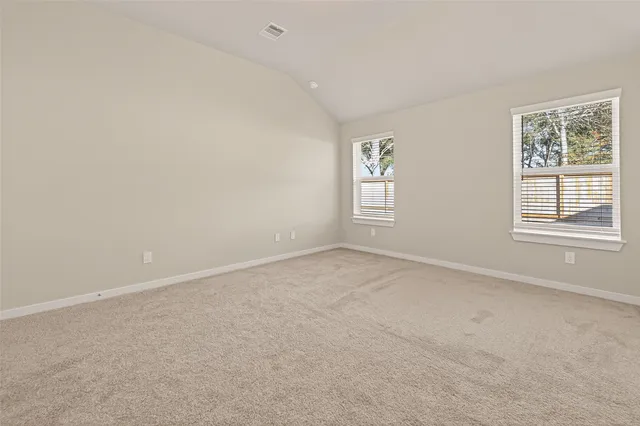 a view of an empty room and closet area