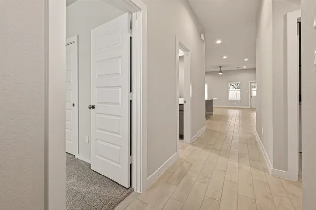 a view of a hallway with wooden shelves