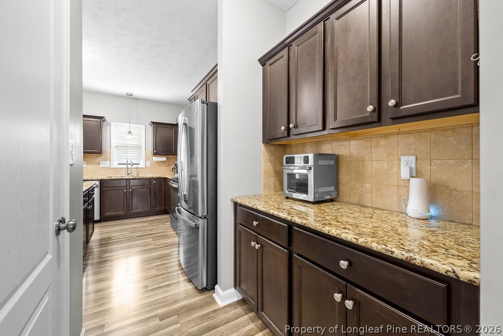 259 Bayleaf Drive Raeford, NC 28376 - Photo 11 of 46 a kitchen with stainless steel appliances granite countertop a sink stove and refrigerator