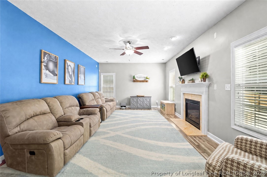 259 Bayleaf Drive Raeford, NC 28376 - Photo 13 of 46 a spacious bedroom with a large bed a flat screen tv and a fireplace