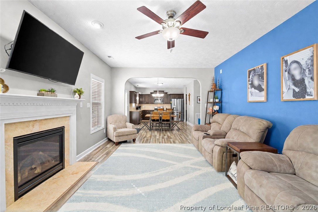 259 Bayleaf Drive Raeford, NC 28376 - Photo 14 of 46 a living room with furniture a flat screen tv and a fireplace