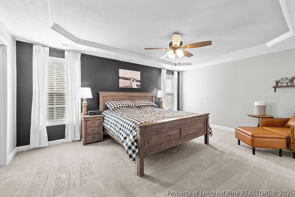 259 Bayleaf Drive Raeford, NC 28376 - Photo 17 of 46 a bedroom with a bed and a chandelier