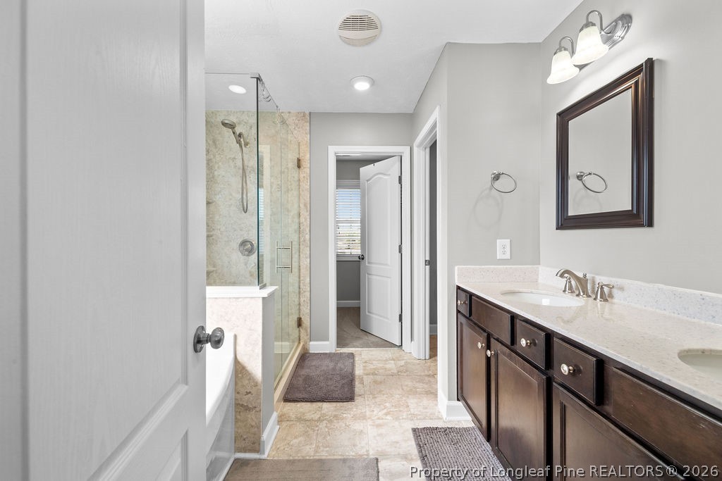 259 Bayleaf Drive Raeford, NC 28376 - Photo 20 of 46 a bathroom with a sink a toilet and shower