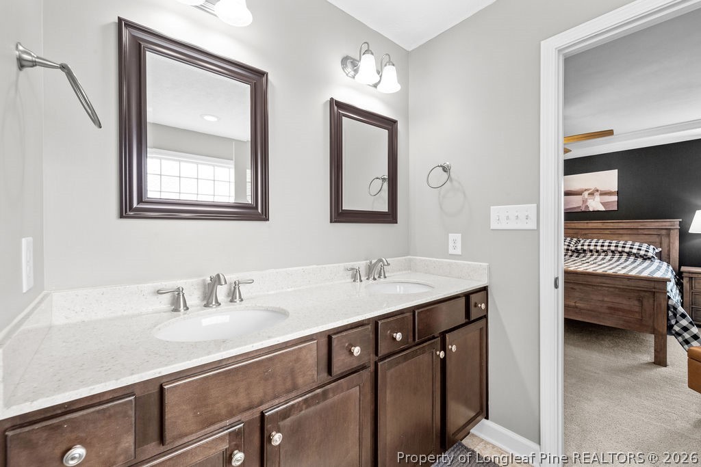 259 Bayleaf Drive Raeford, NC 28376 - Photo 21 of 46 a en suite bathroom with a double vanity sink and a mirror