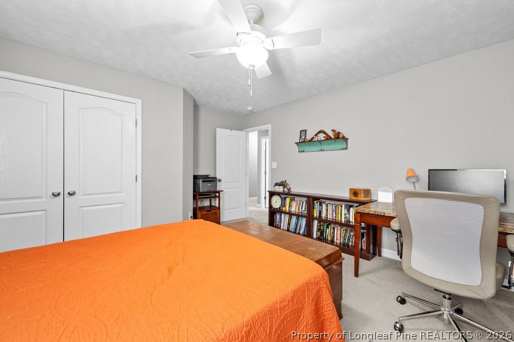 259 Bayleaf Drive Raeford, NC 28376 - Photo 25 of 46 a bedroom with a bed and a chandelier