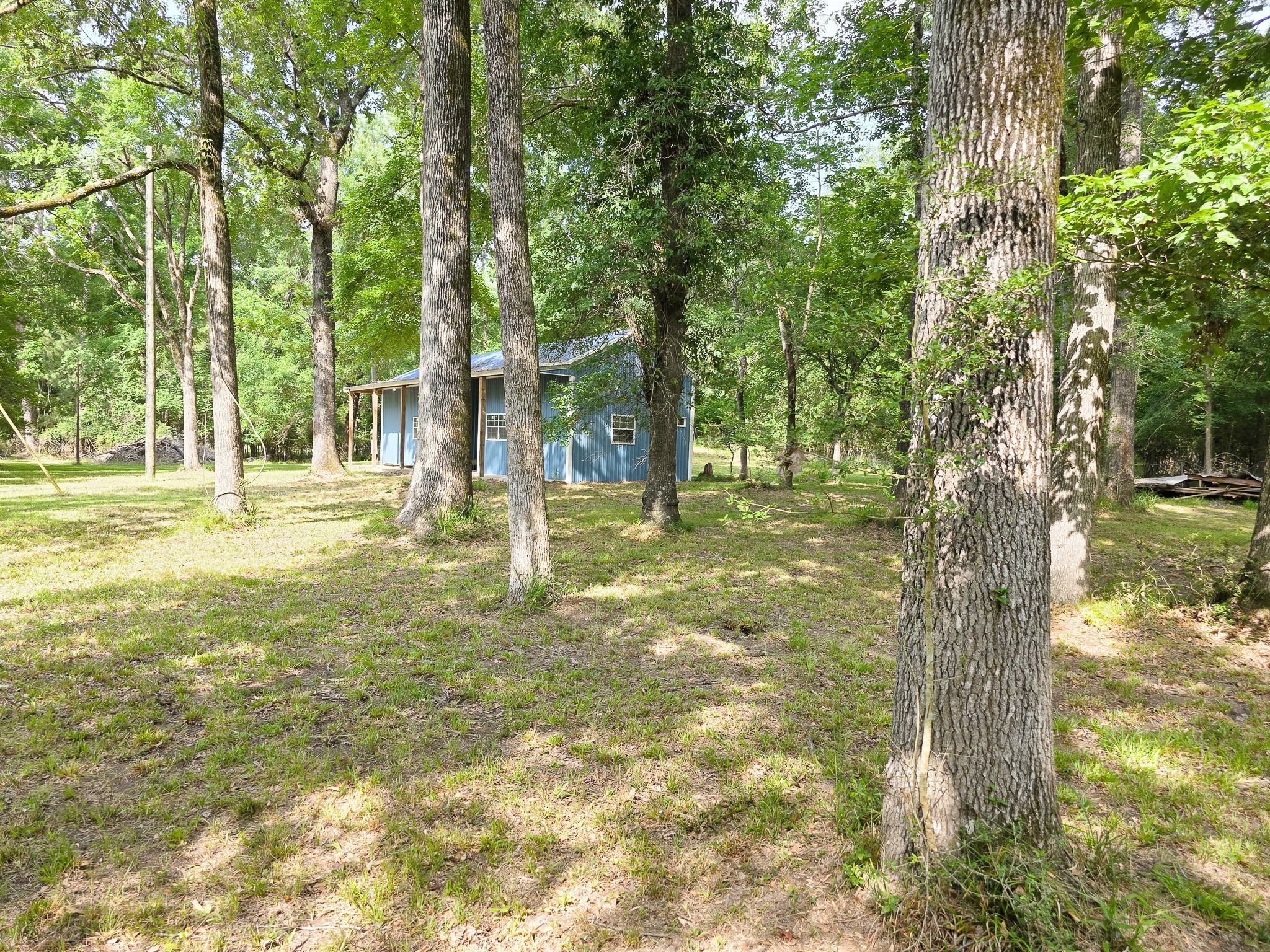 437 East Lumbermans Road Onalaska, TX 77360 - Photo 15 of 15 a backyard of a house with lots of green space and fountain