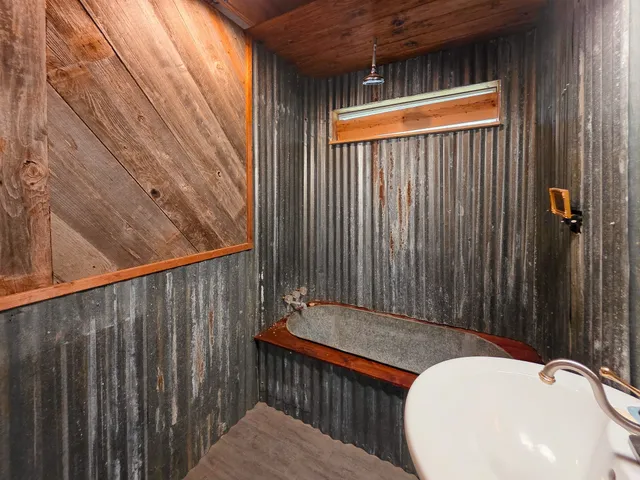 a backyard of a house with a table and chairs