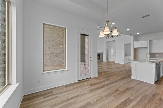 a view of a kitchen and an empty room