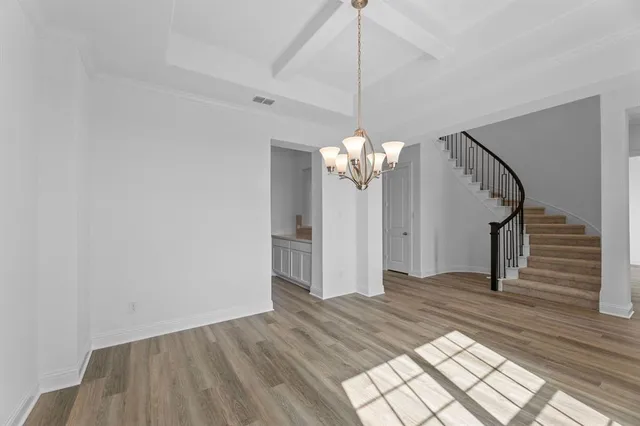 a view of a chandelier fan and wooden floor