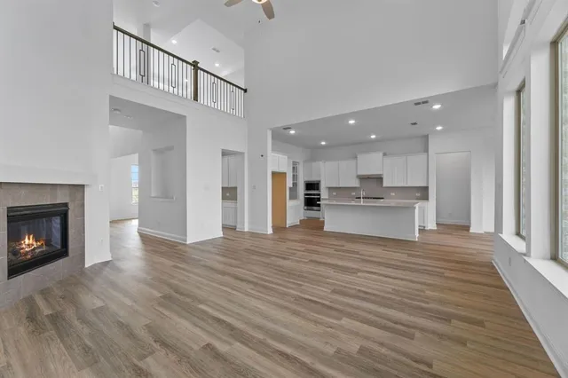 a view of kitchen with kitchen island wooden floor and a refrigerator