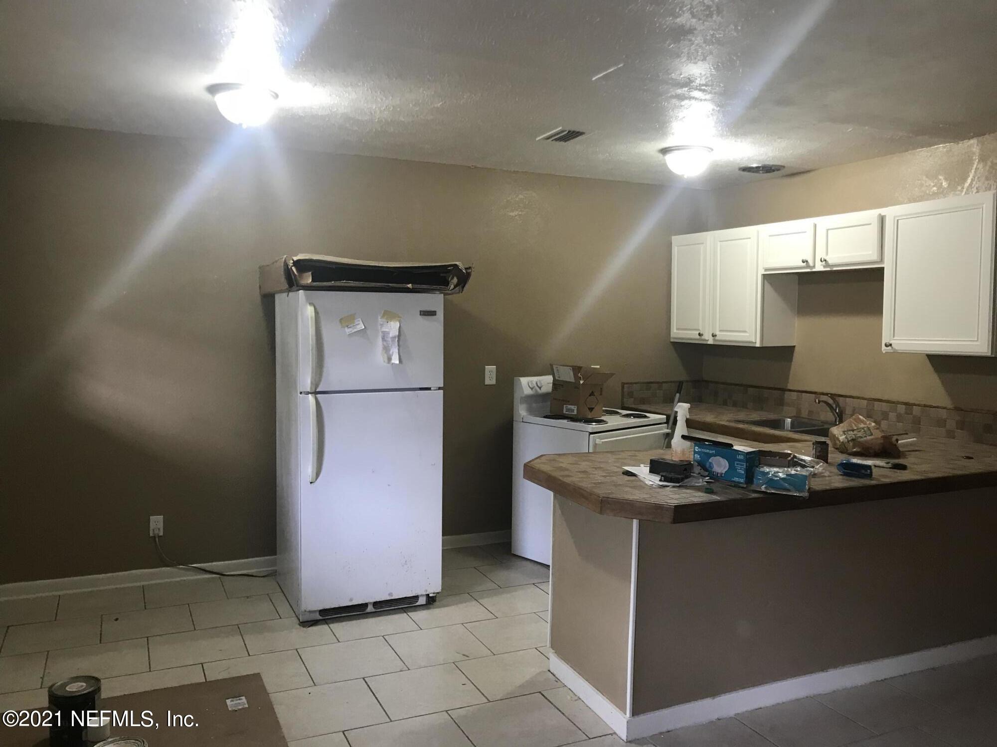 7232 Rutledge Pearson Drive Jacksonville, FL 32209 - Photo 6 of 11 a kitchen with stainless steel appliances granite countertop a sink stove and cabinets