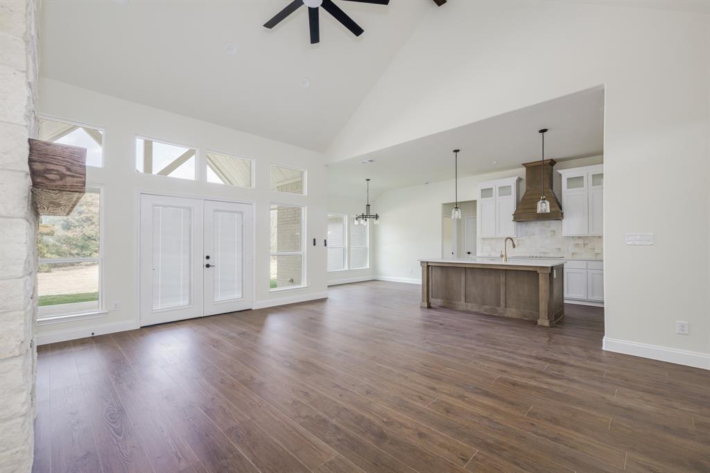 1844 County Road 2320 Terrell, TX 75160 - Photo 12 of 40 a large white kitchen with kitchen island a sink dishwasher and a stove with wooden floor