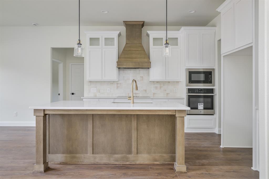 1844 County Road 2320 Terrell, TX 75160 - Photo 16 of 40 a kitchen with stainless steel appliances granite countertop a sink a microwave a refrigerator and white cabinets