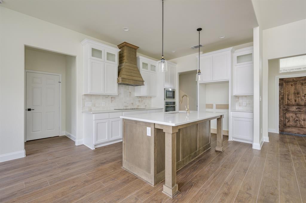 1844 County Road 2320 Terrell, TX 75160 - Photo 17 of 40 a kitchen with a sink cabinets and wooden floor