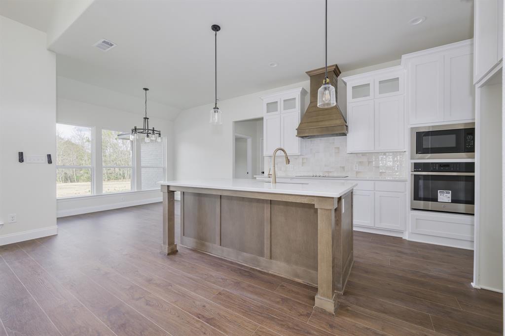 1844 County Road 2320 Terrell, TX 75160 - Photo 18 of 40 a kitchen with wooden floors sink and cabinets
