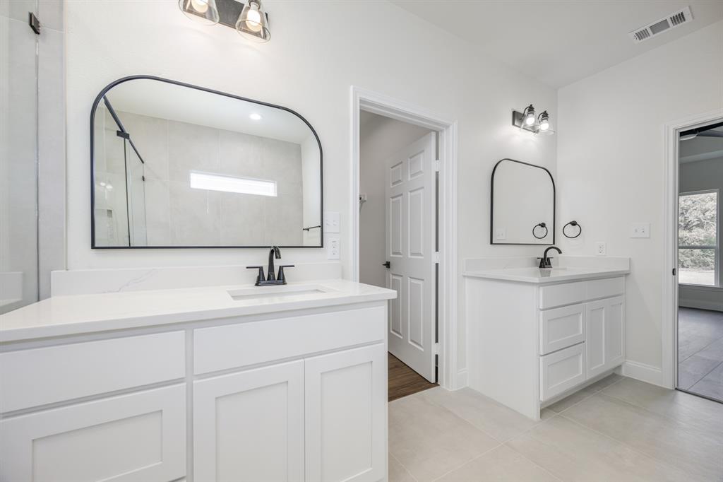 1844 County Road 2320 Terrell, TX 75160 - Photo 29 of 40 a bathroom with a sink and a mirror