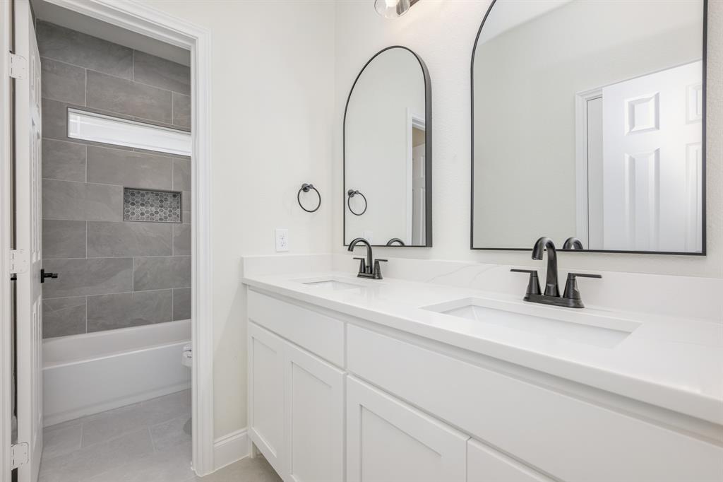 1844 County Road 2320 Terrell, TX 75160 - Photo 38 of 40 a bathroom with a double vanity sink and a mirror