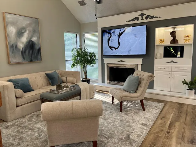 a living room with furniture and a fireplace
