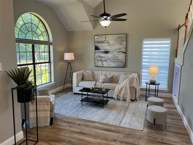 a living room with furniture and a wooden floor