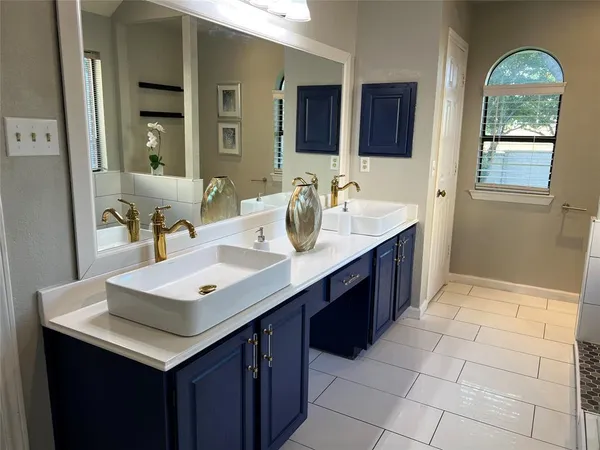a bathroom with a sink vanity and mirror