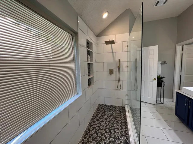 a bathroom with a glass door shower
