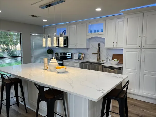 a kitchen with a table and chairs in it