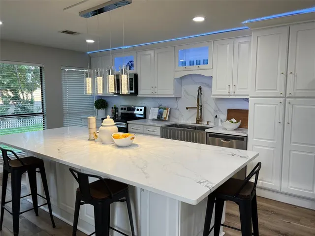 a kitchen with a table and chairs in it