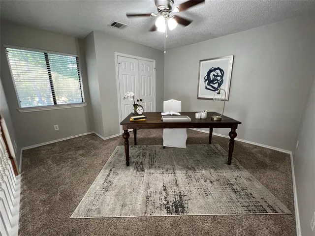 a view of a workspace with furniture