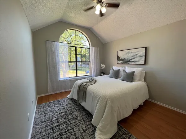 a bedroom with a bed and a window