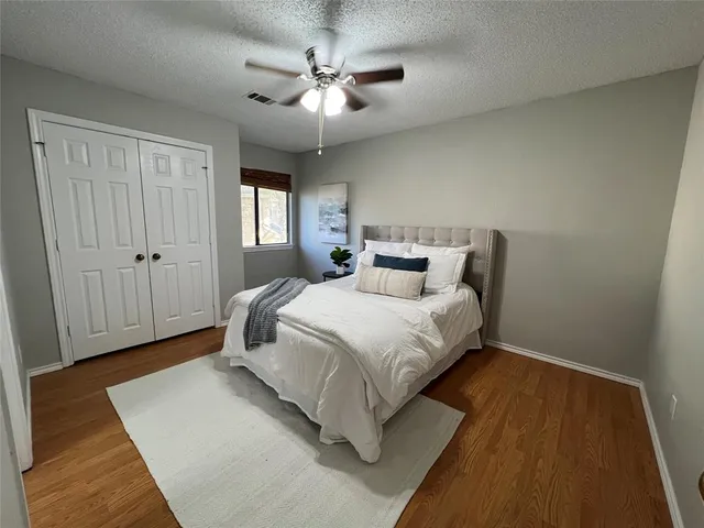 a bedroom with a bed and a ceiling fan