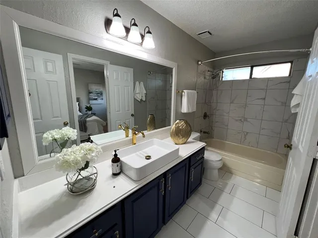 a bathroom with a tub sink and mirror