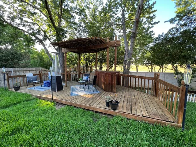 a view of backyard with deck and outdoor seating