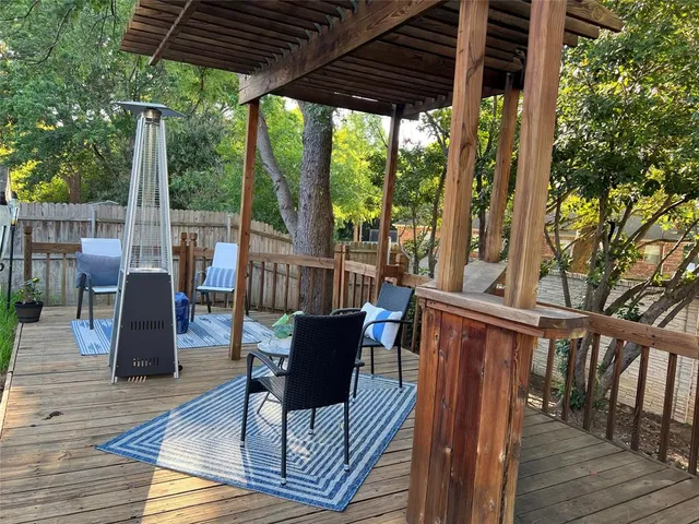 a view of balcony with wooden floor and outdoor seating