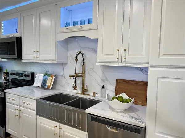 a kitchen with stainless steel appliances granite countertop a sink and cabinets