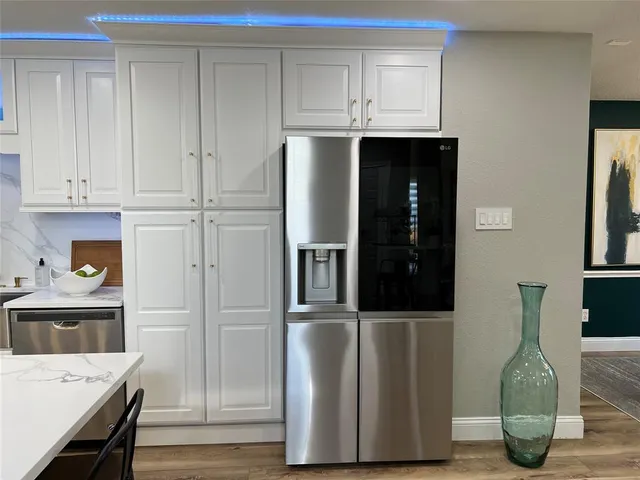 a kitchen with stainless steel appliances granite countertop a refrigerator and microwave