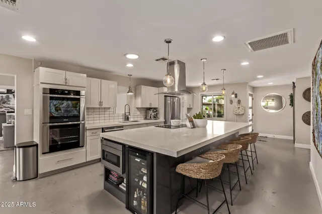 a large kitchen with a table and chairs