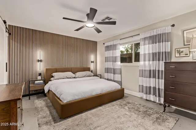 a bedroom with a large bed and a window