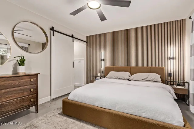 a bedroom with a bed and a dresser