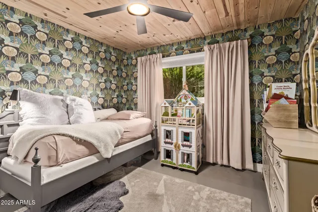 a bedroom with furniture and a large window