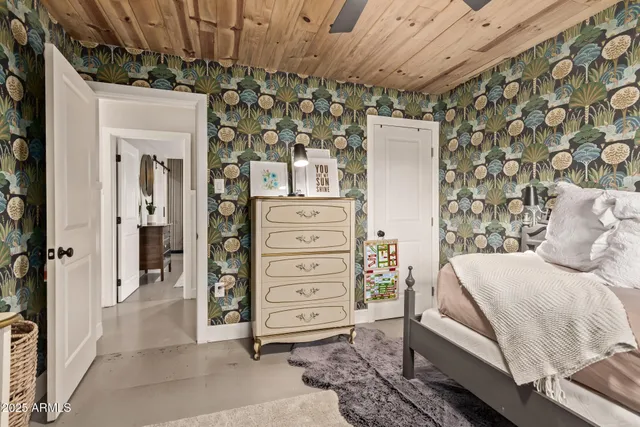 a bedroom with a bed and a mirror