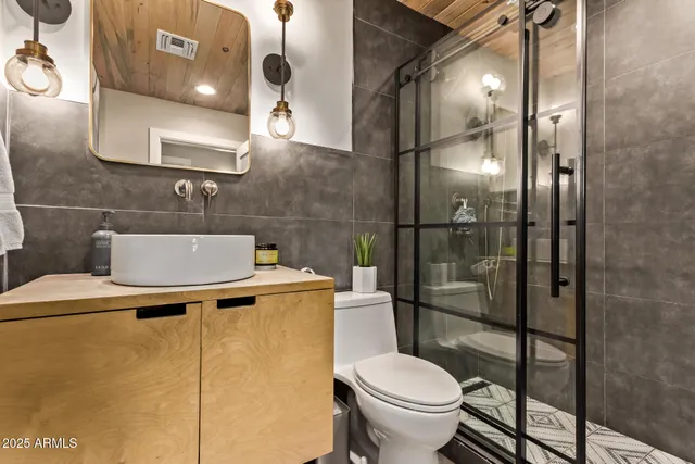 a bathroom with a toilet and a shower
