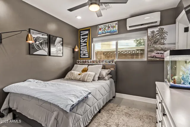 a bedroom with a bed and a large window