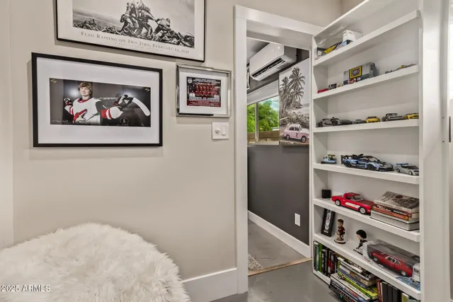 a room with a book shelf and a shelf