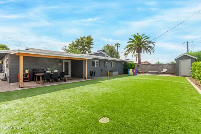 a front view of house with yard and outdoor seating